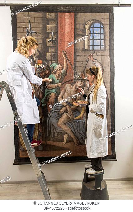Restoration atelier, women, restorers stand on ladder and restore a lent scarf, Munich, Bavaria, Germany