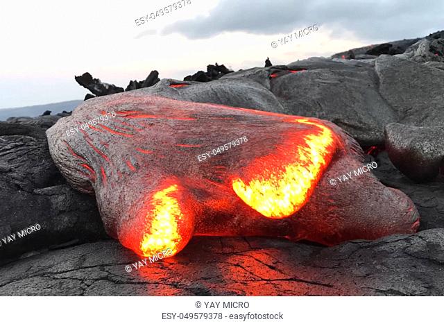 Pouring lava on the slope of the volcano. Volcanic eruption and magma