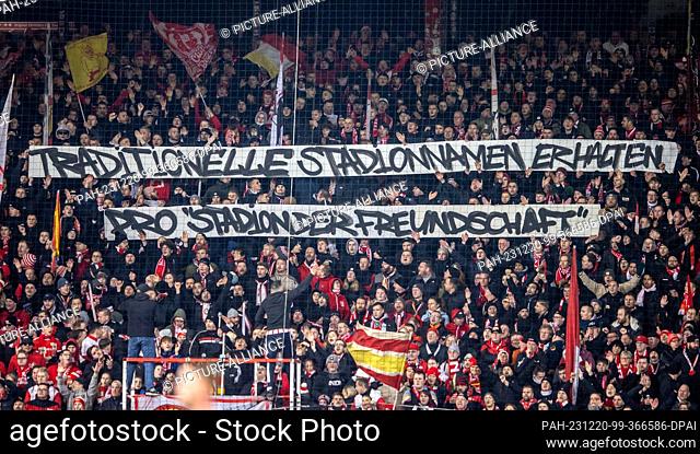20 December 2023, Berlin: Soccer: Bundesliga, 1. FC Union Berlin - 1. FC Köln, Matchday 16, An der Alten Försterei. Union fans hold banners with the slogan:...