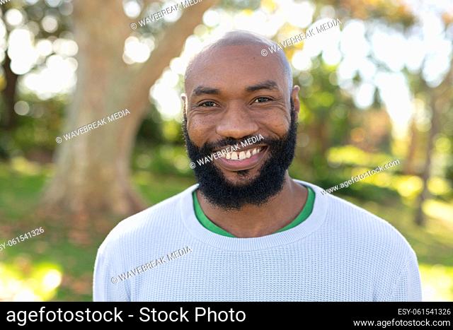 Image of happy african american man smiling at camera