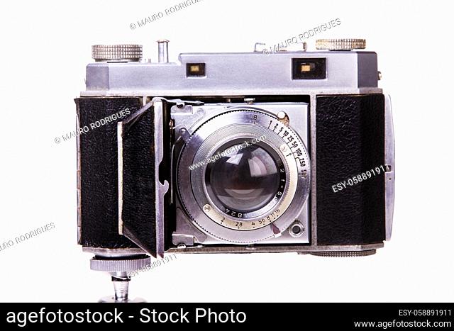 Close up view of a retro vintage photographic camera isolated on a white background