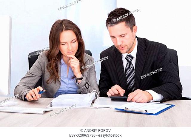 Businesspeople Calculating Finance