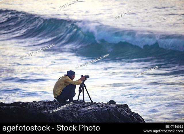 Photographer at work on the beach of Praia de Santa Barbara, Ribeira Grande, Sao Miguel Island, Azores, Portugal, Europe