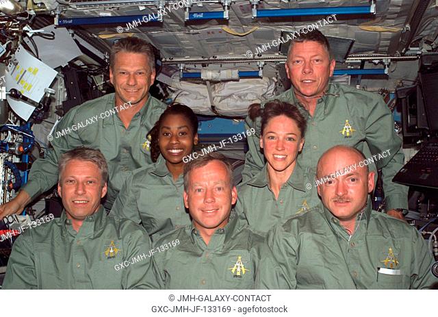 European Space Agency (ESA) astronaut Thomas Reiter, new Expedition 13 crewmember, and the STS-121 crew gather for an in-flight portrait in the Destiny...