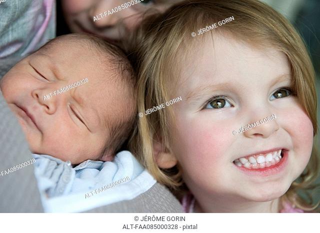 Girl with baby brother, portrait