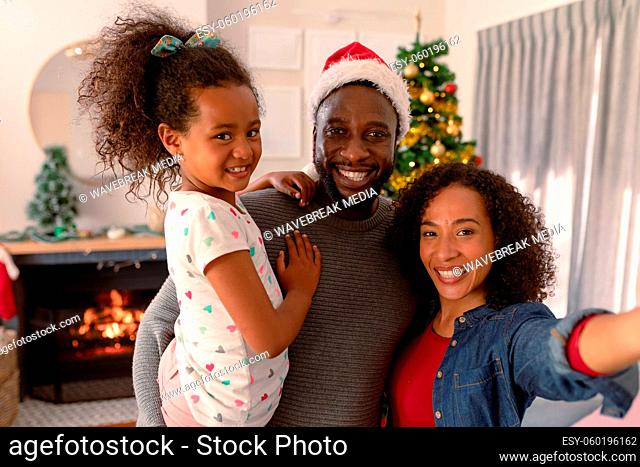 Happy african american parents and daughter taking selfie