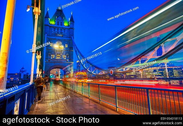 Vehicles pass over Tower Bridge across the River Thames in London, UK
