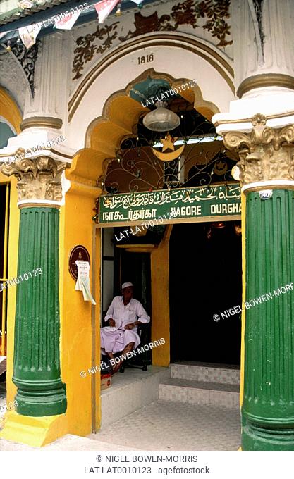 An Indian Muslim Nagore Durgha shrine in Telok Ayer Street, Chinatown. Man in White Robe Sitting