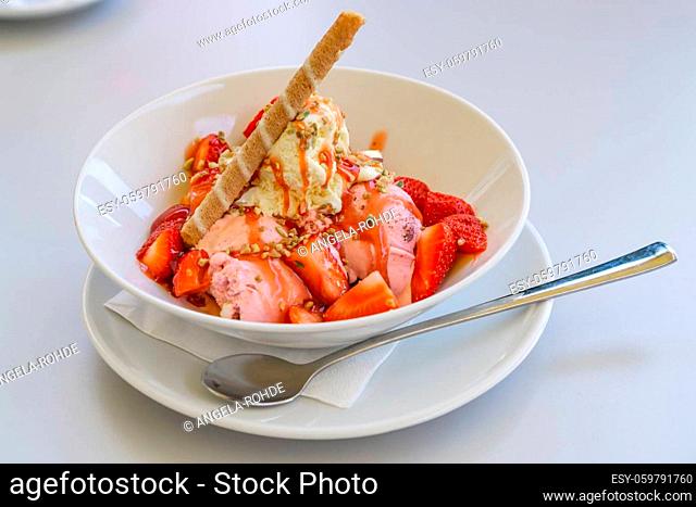 Ice cream cup with fresh strawberries