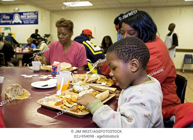 Detroit, Michigan - Three-year-old Matthew Malone eats lunch at the Capuchin soup kitchen  The soup kitchen dates to 1929 and now serves about 1600 meals a day...