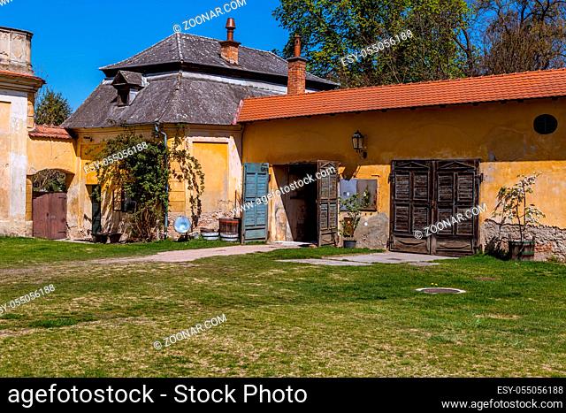 Old farm building and dwelling house, climbing roses and flowers, picturesque windows and doors it is a romantic corner near Milotice Castle, South Moravia