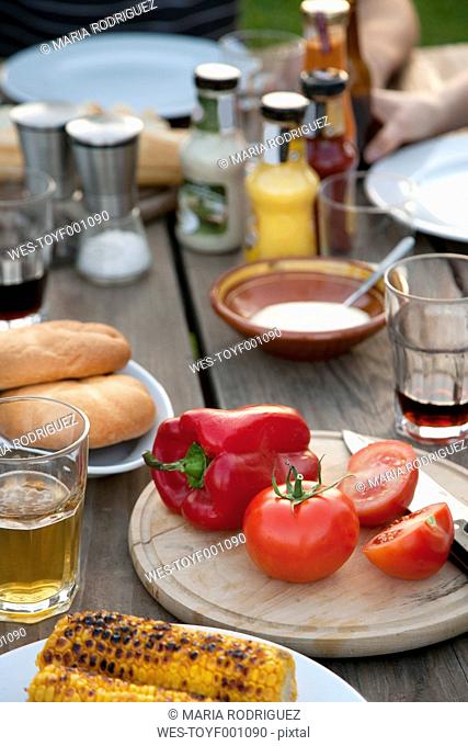 Laid garden table with vegetable and drinks