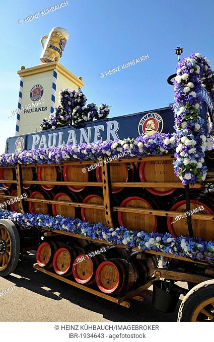 Wood barrels from the Paulaner Brewery on a horse-drawn cart in front of the Paulaner beer tower, Oktoberfest 2010, Munich, Upper Bavaria, Bavaria, Germany