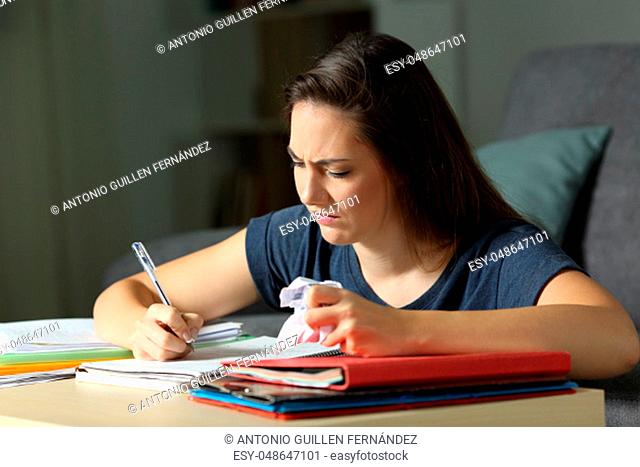Frustrated student working late hours in the night at home