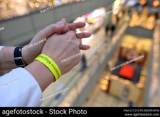 15 December 2021, Saxony-Anhalt, Magdeburg: A ""2G-strap"" on the arm of a woman in the shopping center ""Allee-Center"" in the city center of the capital of...