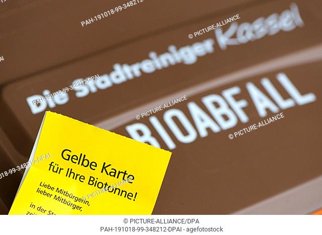 18 October 2019, Hessen, Kassel: A sticker with the inscription ""Yellow card for your organic waste bin"" is attached to an organic waste bin at the Kassel...