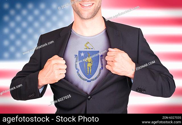 Businessman opening suit to reveal shirt with state flag (USA), Massachusetts
