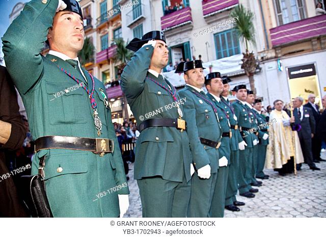 Policemen saluting as a Float passes by, Semana Santa Holy Week Malaga, Andalusia, Spain