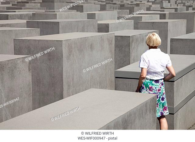 Germany, Berlin, Holocaust Memorial, Mature woman between steles