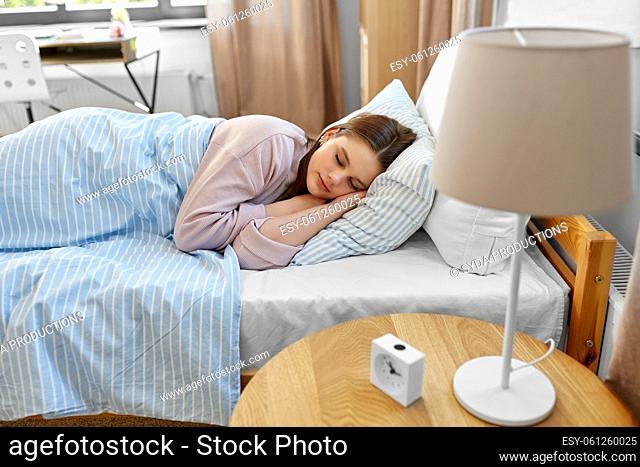 girl sleeping in bed at home in morning