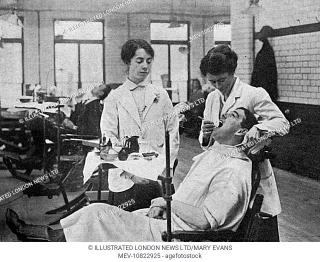 Women at the National Dental Hospital and college in Great Portland Street being taught in the conservation room how to stop and fill decayed teeth