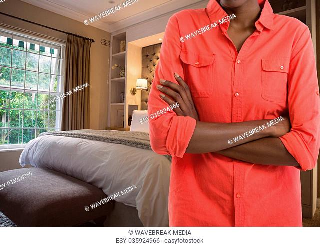 woman folding arms in bedroom