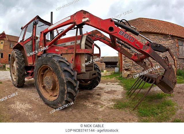 England, Somerset, Taunton. A tractor parked in a farmyard