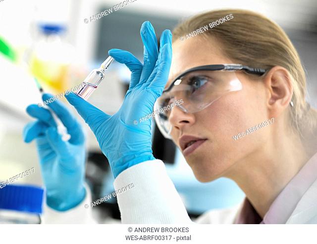 Pharmaceutical Research, Scientist preparing a new drug for testing in the laboratory