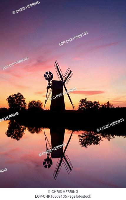 England, Norfolk, Near How Hill, Turf Fen drainage mill at sunset on the River Ant in the Norfolk Broads