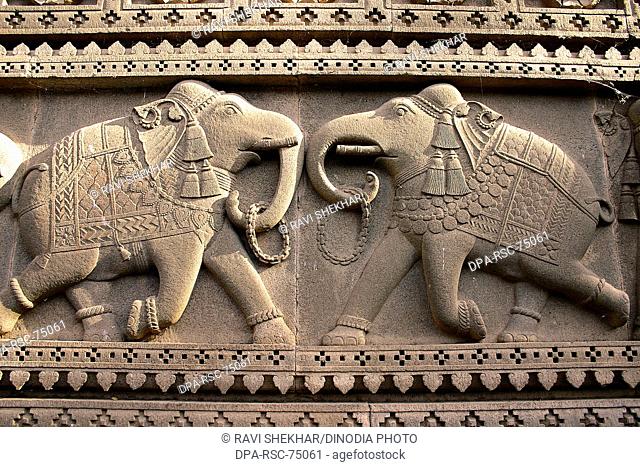 Two elephants with garlands in their trunks as welcome sign , carved on the wall of Ahilayabai temple , in building on  Ahilayabai ghat of Narmada river