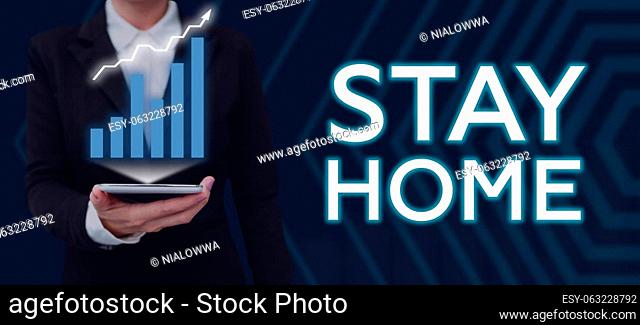 Text sign showing Stay Home, Business concept not go out for an activity and stay inside the house or home