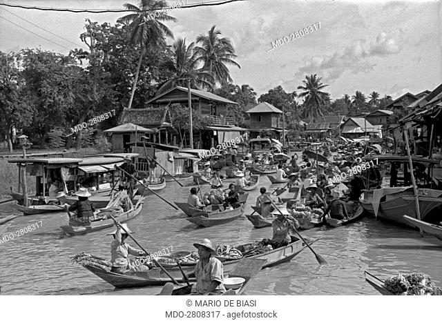 Pirogues full of fruits and greens sailing the river Chao Phraya. Bangkok, 1961