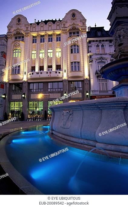 Part view of Maximillian Fountain and the Cafe Rolanda on Hlavne nam (main square) at night