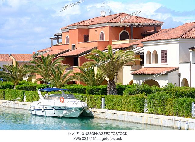 Motor yacht at houses and palm trees in Lido di Policoro, Basilicata, Italy, Mediterranean Sea, Europe