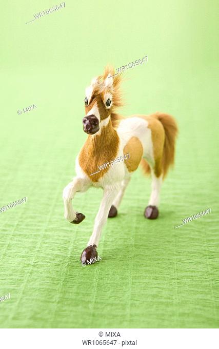 Toy Horse on Green Paper