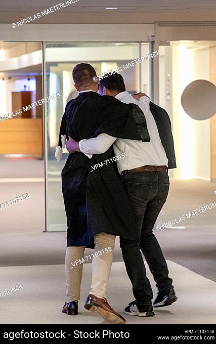 Ibrahim Farisi embraces lawyer Michel Degreve after receiving a not-guilty verdict at a session to read the verdict of the trial of the terrorist attacks of...