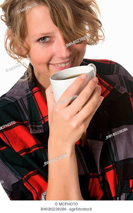 young manufacturer taking a coffee break with a content smile