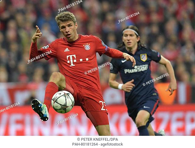 Munich's Thomas Mueller (L) in action against Madrid's Filipe Luis during the UEFA Champions League semi final second leg soccer match between Bayern Munich and...