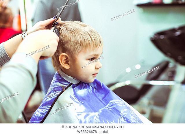 Little boy with blond hair cut at a barber shop using machine, Stock Photo,  Picture And Royalty Free Image. Pic. WR3326678 | agefotostock