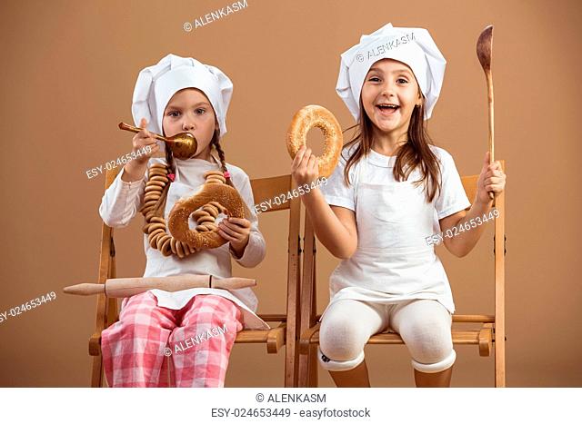 Two 5 years old girls bakers studio shot