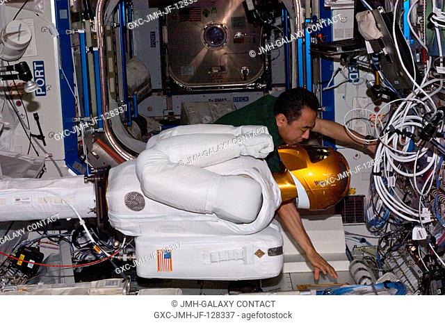 Japan Aerospace Exploration Agency astronaut Satoshi Furukawa and NASA astronaut Mike Fossum (out of frame), both Expedition 28 flight engineers