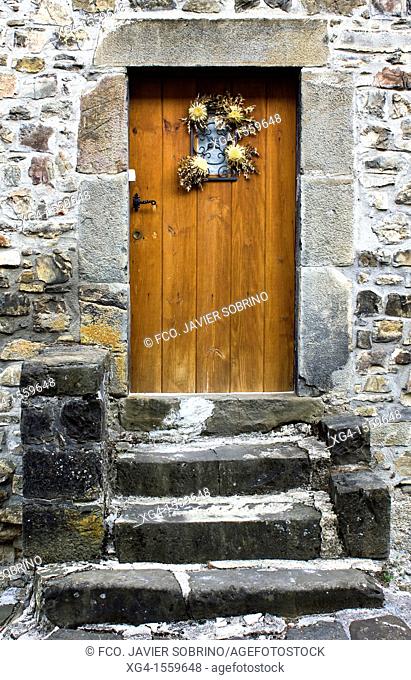 Carlin in the door of a house Isaba - Roncal Valley - Pyrenees - Pyrenees Navarro - Navarra - Spain - Europe