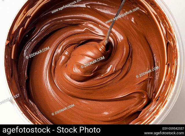 Background of chocolate paste with spoon in a basket