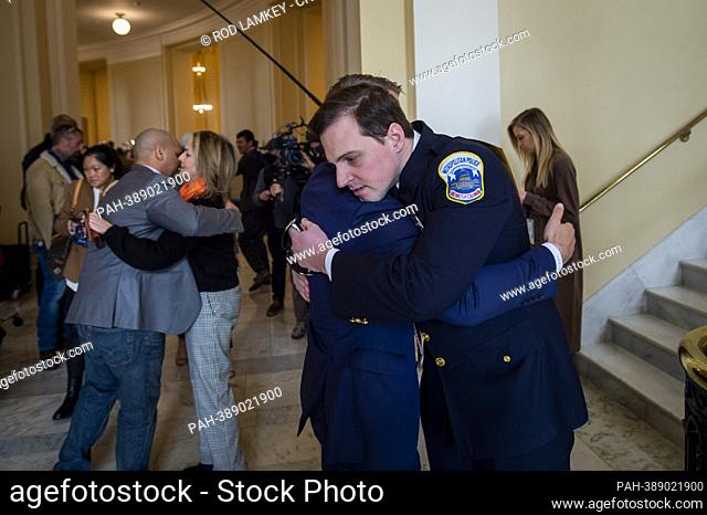 Former Capitol Police Sergeant Aquilino Gonell, left, is embraced by United States Representative Madeleine Dean (Democrat of Pennsylvania), second from left