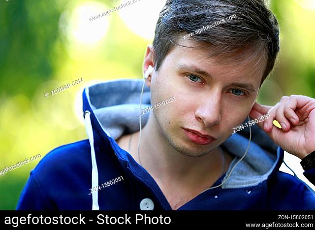 Belarus, Gomel, September 15, 2016. Central Park, a city holiday. Portrait of a young man with headphones