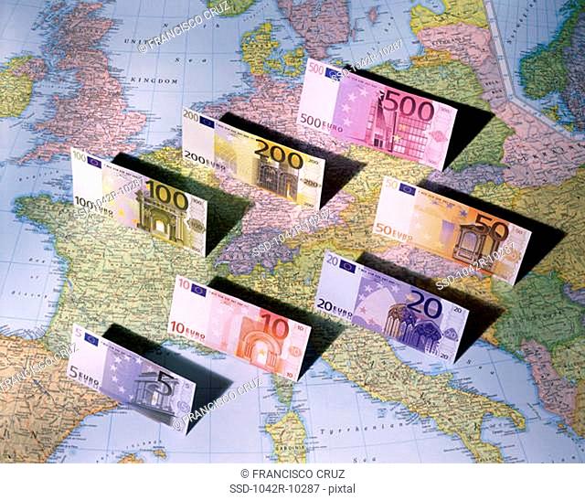Euro banknotes on a map