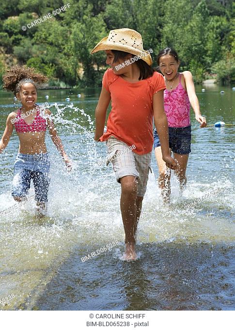Young girls splashing in lake