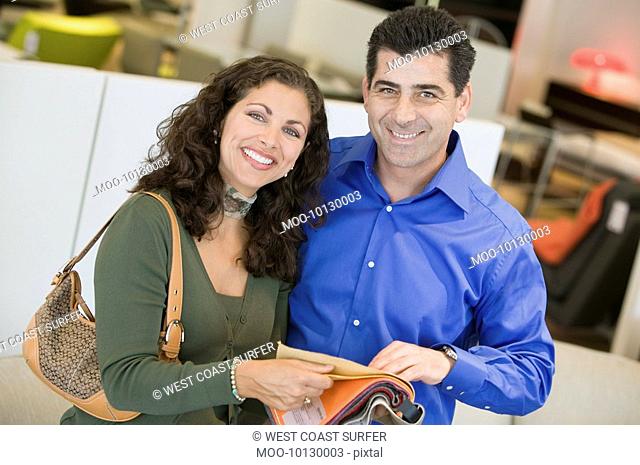 Couple in store looking at Fabric Swatches portrait
