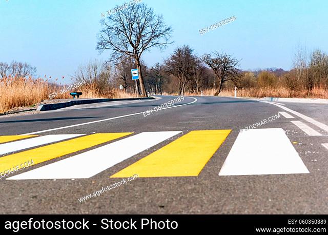 pedestrian crossing strips, yellow and white lines on asphalt