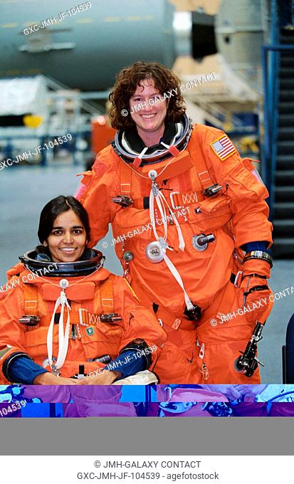 Astronauts Kalpana Chawla (seated) and Laurel B. Clark, both STS-107 mission specialists, are photographed prior to a training session in the Space Vehicle...